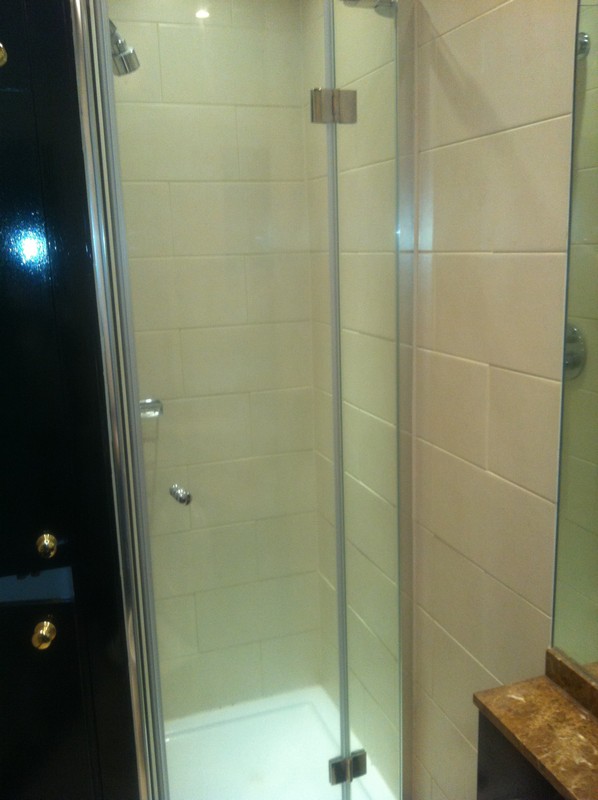 Frameless glass shower enclosure with chrome fittings in West Drayton